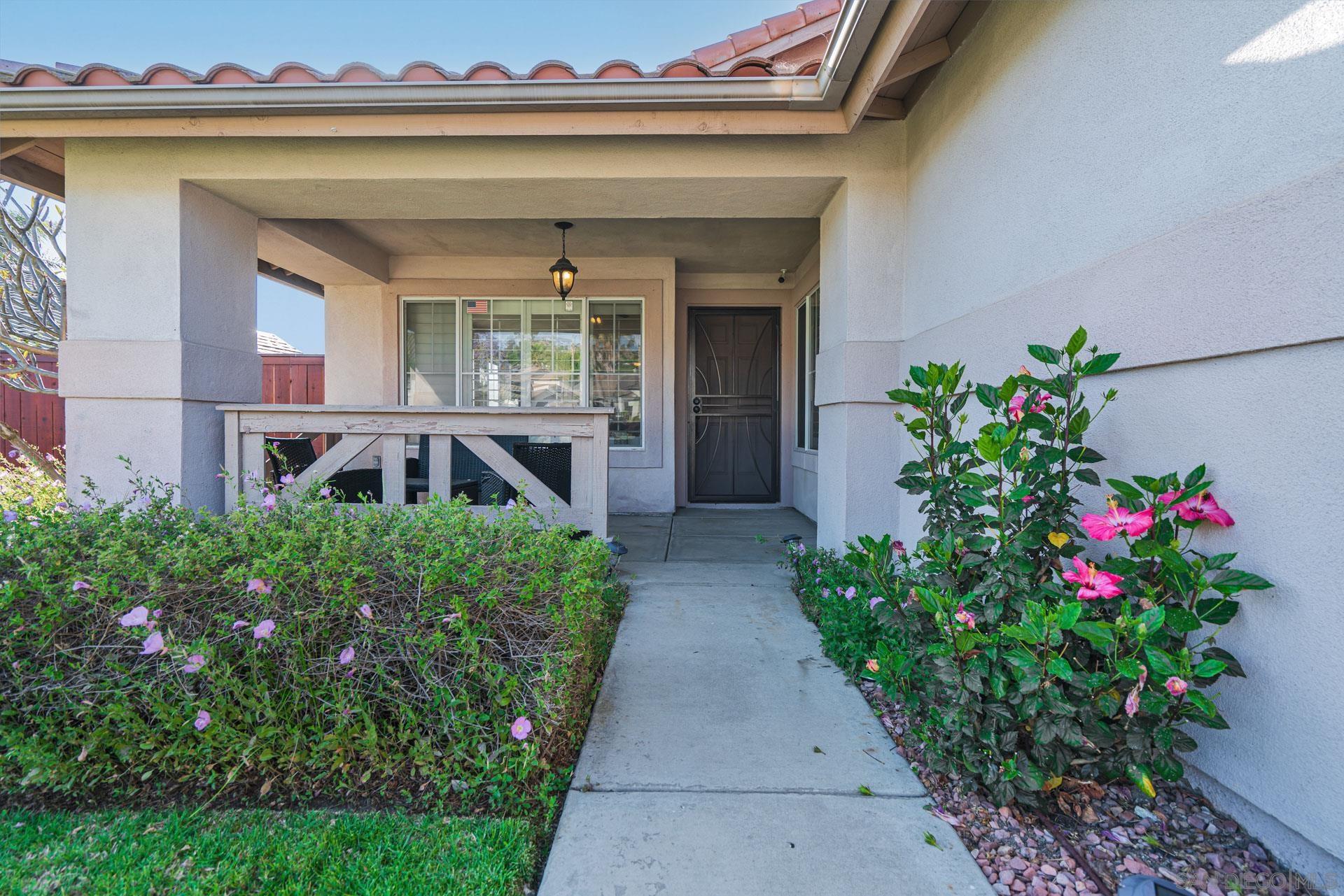 3396 Monique Lane Spring Valley, CA 91977 - Photo 23 of 31 a front view of a house with a yard and fountain
