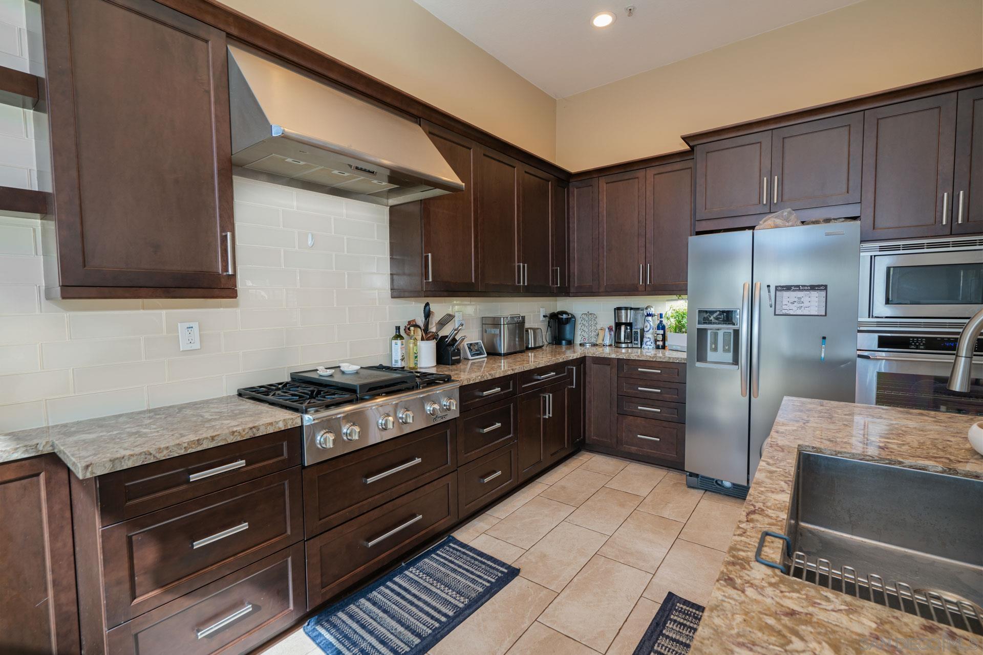 3396 Monique Lane Spring Valley, CA 91977 - Photo 26 of 31 a kitchen with stainless steel appliances granite countertop a stove a sink and a refrigerator