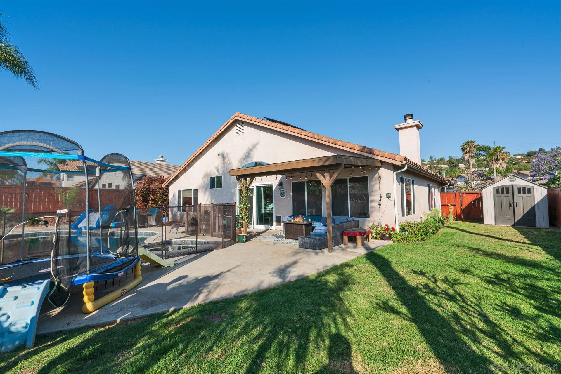 3396 Monique Lane Spring Valley, CA 91977 - Photo 30 of 31 a front view of a house with a yard table and chairs