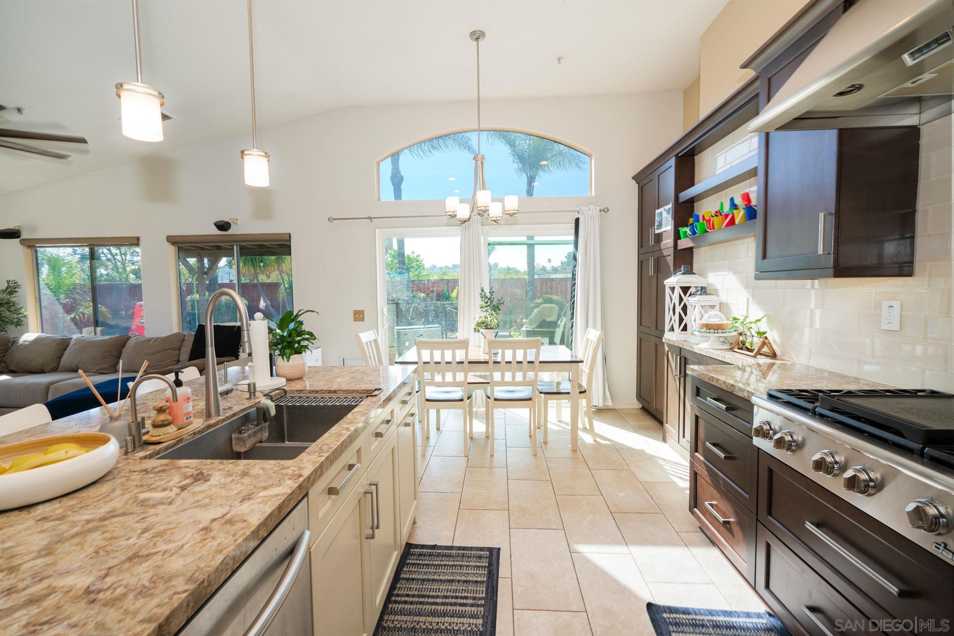 3396 Monique Lane Spring Valley, CA 91977 - Photo 9 of 31 a kitchen with stainless steel appliances granite countertop a stove and a view of living room