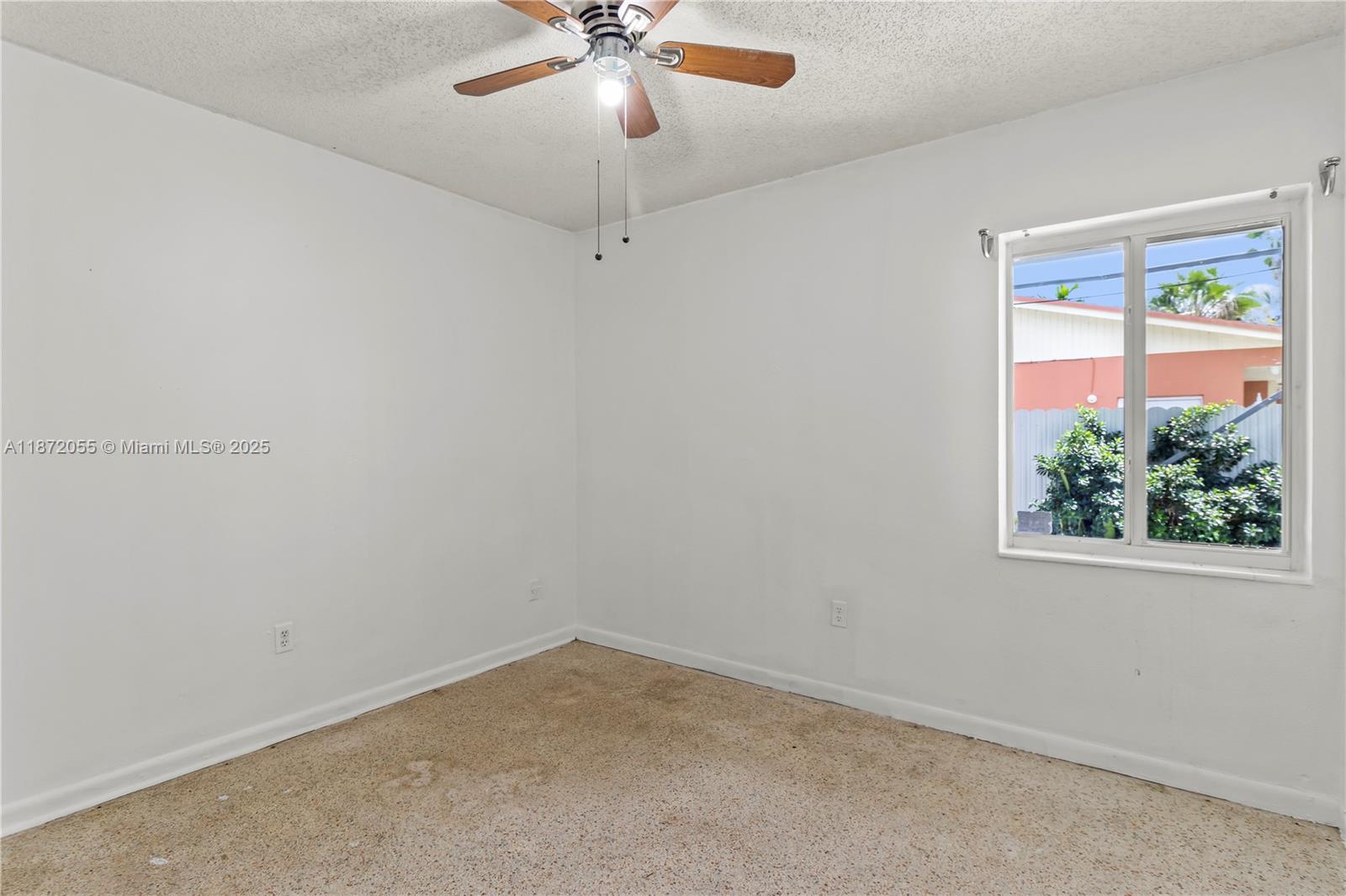 10615 Southwest 200th Street Cutler Bay, FL 33157 - Photo 14 of 35 an empty room with a window and a fan