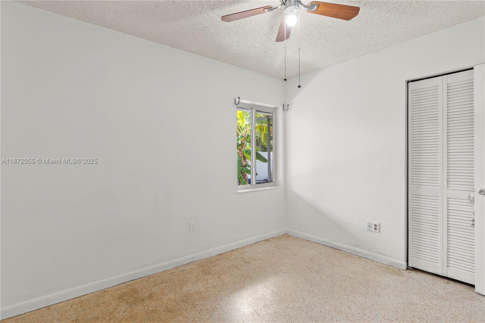 10615 Southwest 200th Street Cutler Bay, FL 33157 - Photo 15 of 35 an empty room with windows and fan