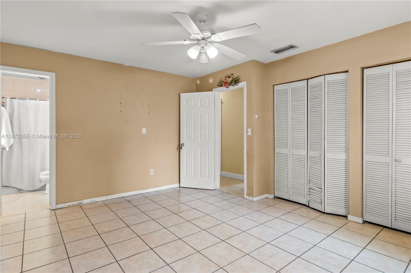 10615 Southwest 200th Street Cutler Bay, FL 33157 - Photo 20 of 35 wooden floor in an empty room with a window