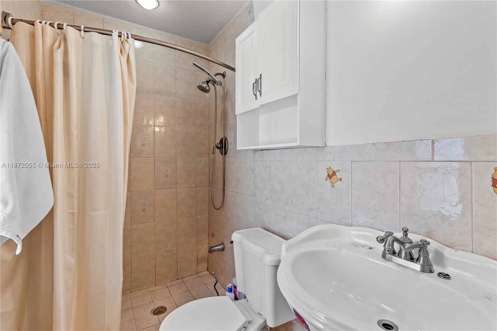 10615 Southwest 200th Street Cutler Bay, FL 33157 - Photo 22 of 35 a bathroom with a sink toilet and shower