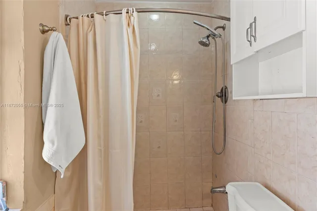 a bathroom with a shower curtain and a shower curtain