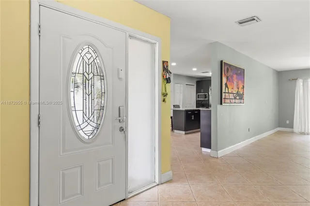 a view of a hallway with entryway wooden floor and front door
