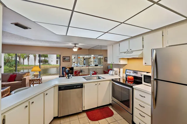 a kitchen with stainless steel appliances a sink cabinets and a refrigerator