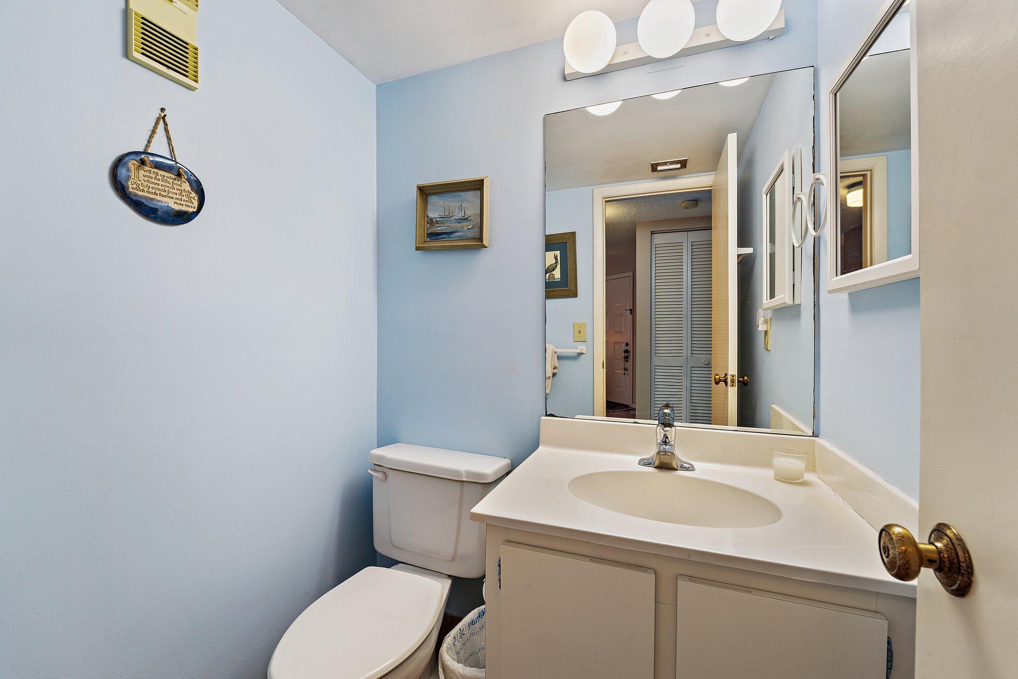 1605 Highway 1, Unit B104 Jupiter, FL 33477 - Photo 15 of 24 a bathroom with a toilet sink and mirror