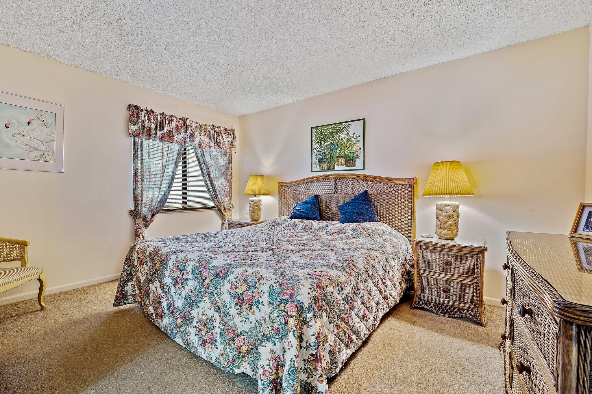1605 Highway 1, Unit B104 Jupiter, FL 33477 - Photo 16 of 24 a bedroom with bed and window