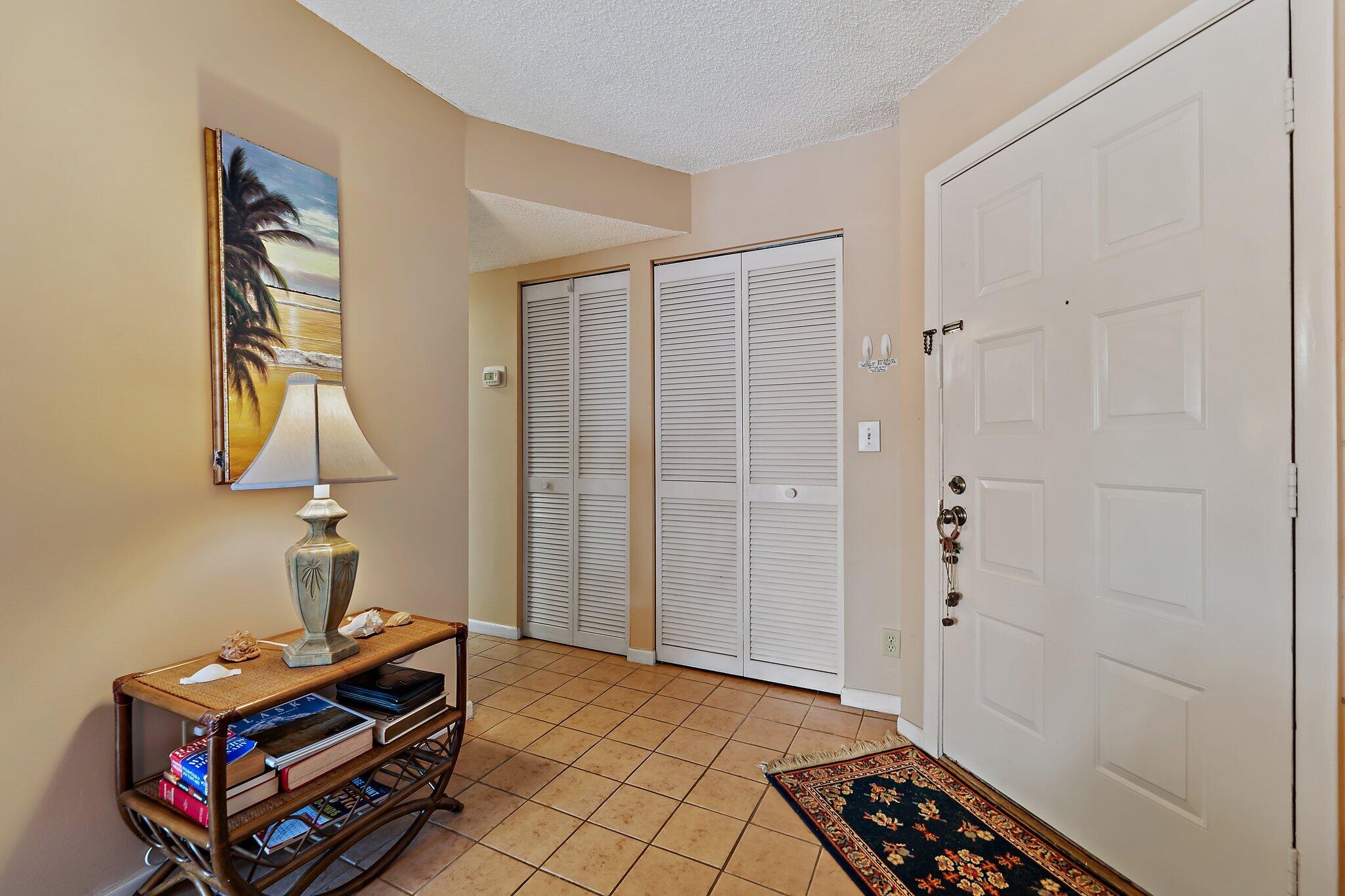 1605 Highway 1, Unit B104 Jupiter, FL 33477 - Photo 3 of 24 a room that has a bed and a dresser in it