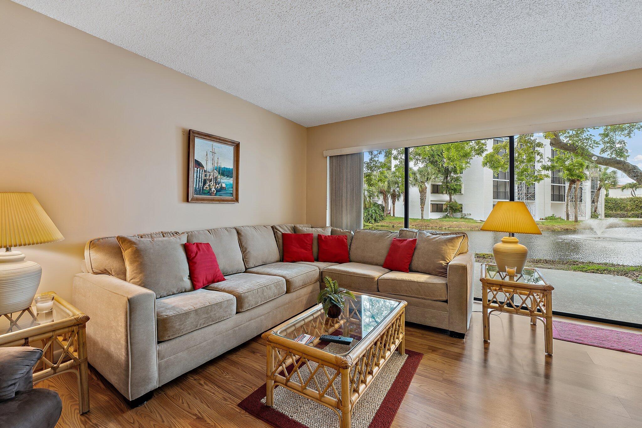 1605 Highway 1, Unit B104 Jupiter, FL 33477 - Photo 5 of 24 a living room with furniture and a large window
