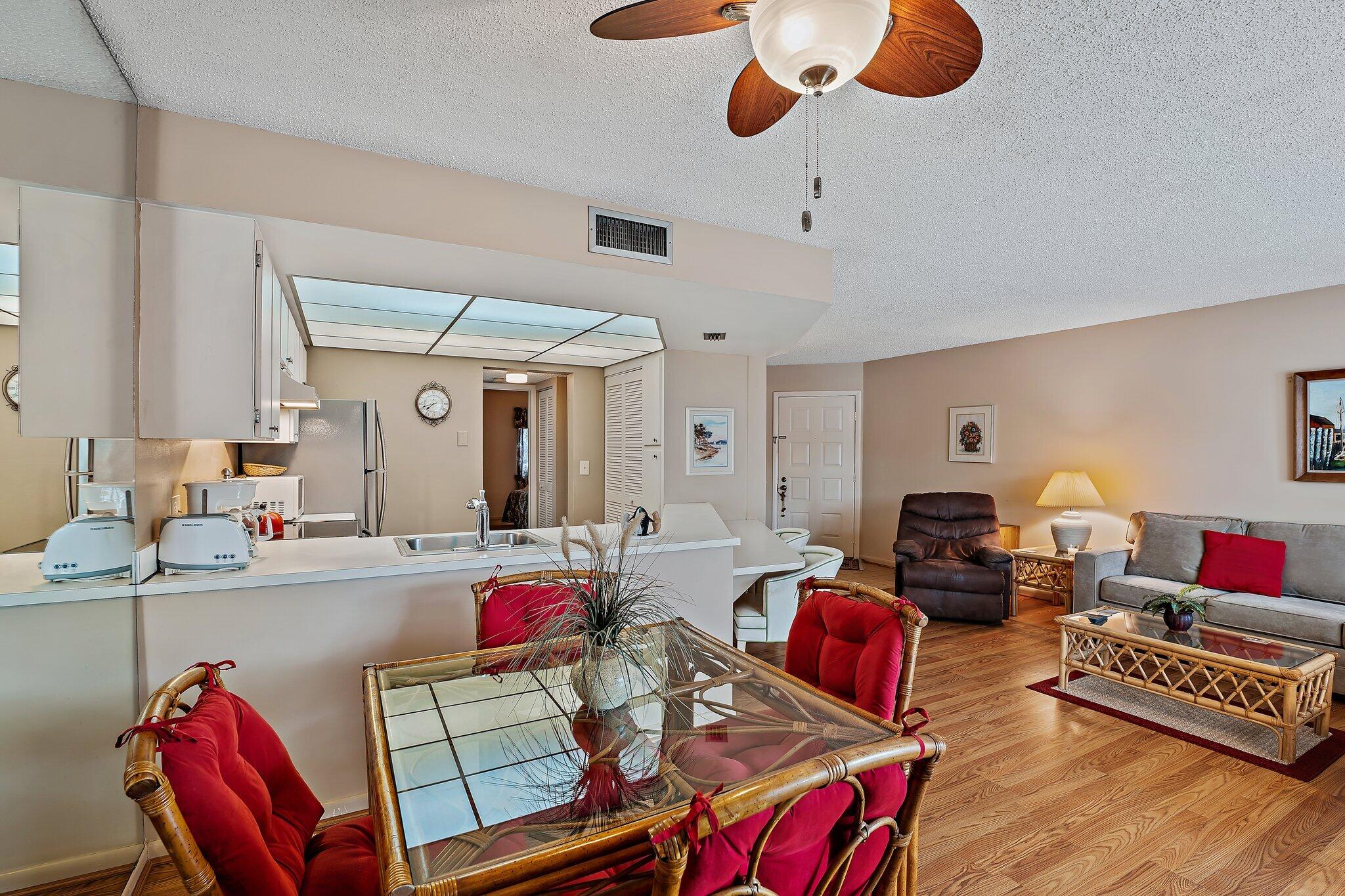 1605 Highway 1, Unit B104 Jupiter, FL 33477 - Photo 8 of 24 a living room with furniture kitchen view and a wooden floor