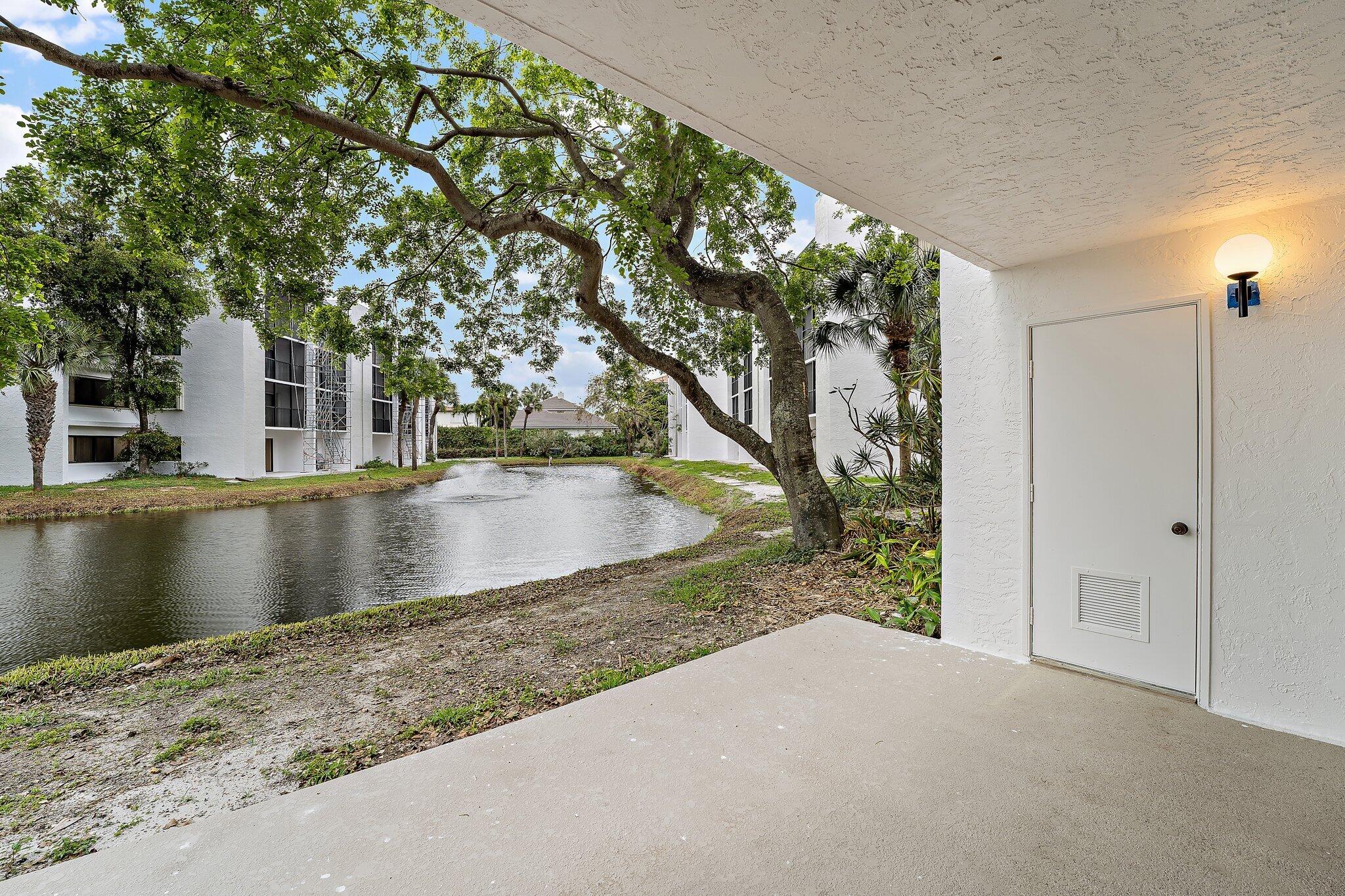 1605 Highway 1, Unit B104 Jupiter, FL 33477 - Photo 9 of 24 a view of a lake with a tree