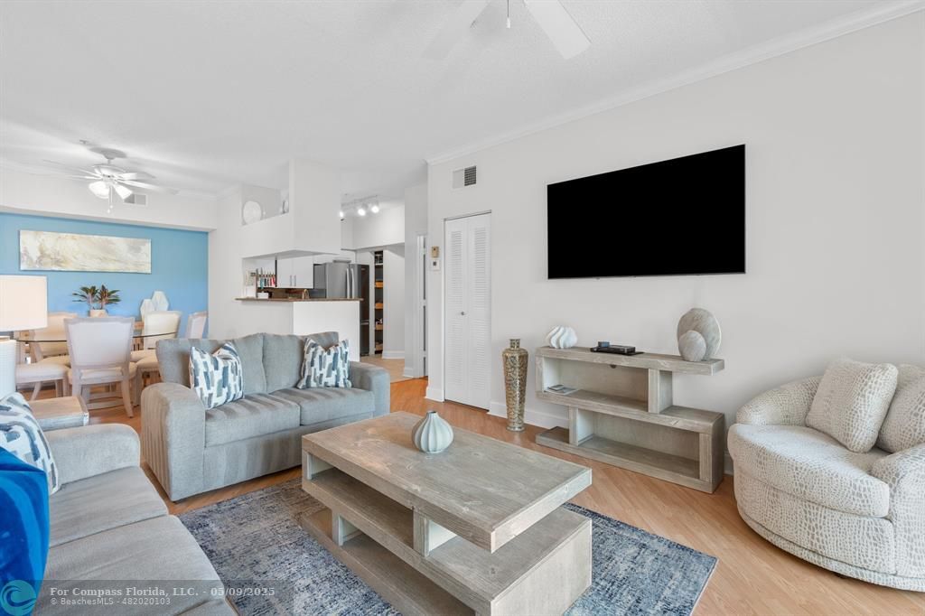 2417 Tuscany Way, Unit 2417 Boynton Beach, FL 33435 - Photo 12 of 27 a living room with furniture and a flat screen tv