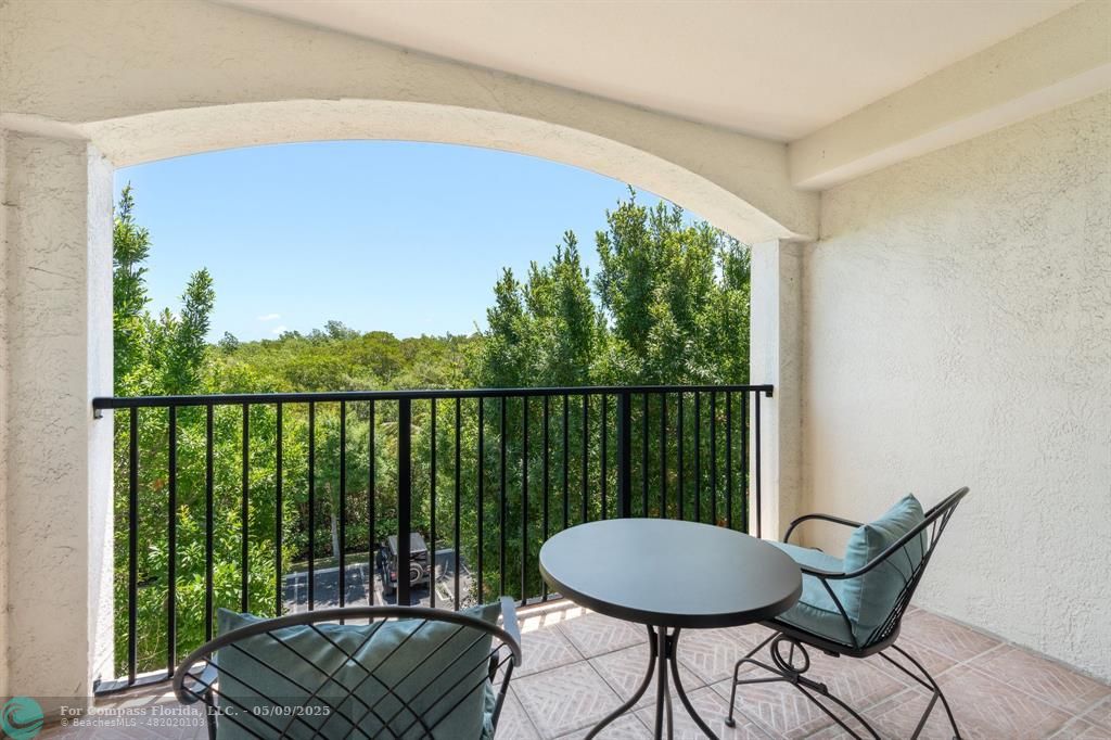 2417 Tuscany Way, Unit 2417 Boynton Beach, FL 33435 - Photo 13 of 27 a view of a balcony with chair and table