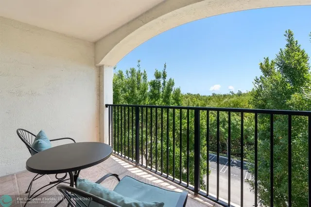 a balcony with table and chairs