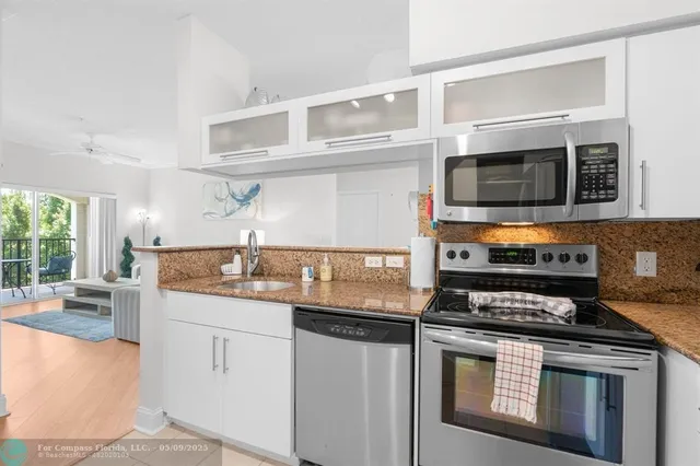 a kitchen with stainless steel appliances granite countertop a stove and a microwave