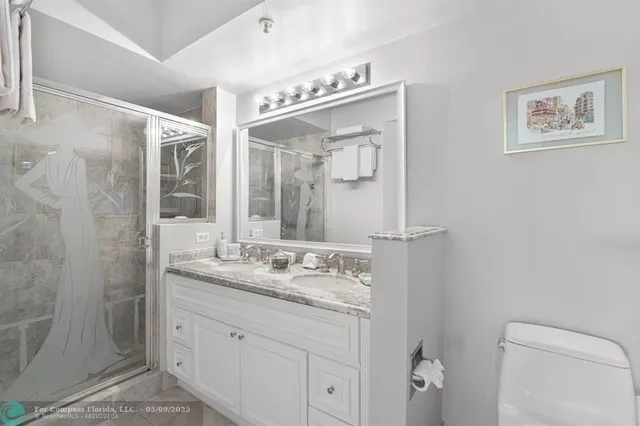 a bathroom with a granite countertop sink mirror and double