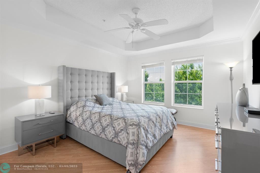 2417 Tuscany Way, Unit 2417 Boynton Beach, FL 33435 - Photo 19 of 27 a bedroom with a bed and a flat tv screen on the dresser