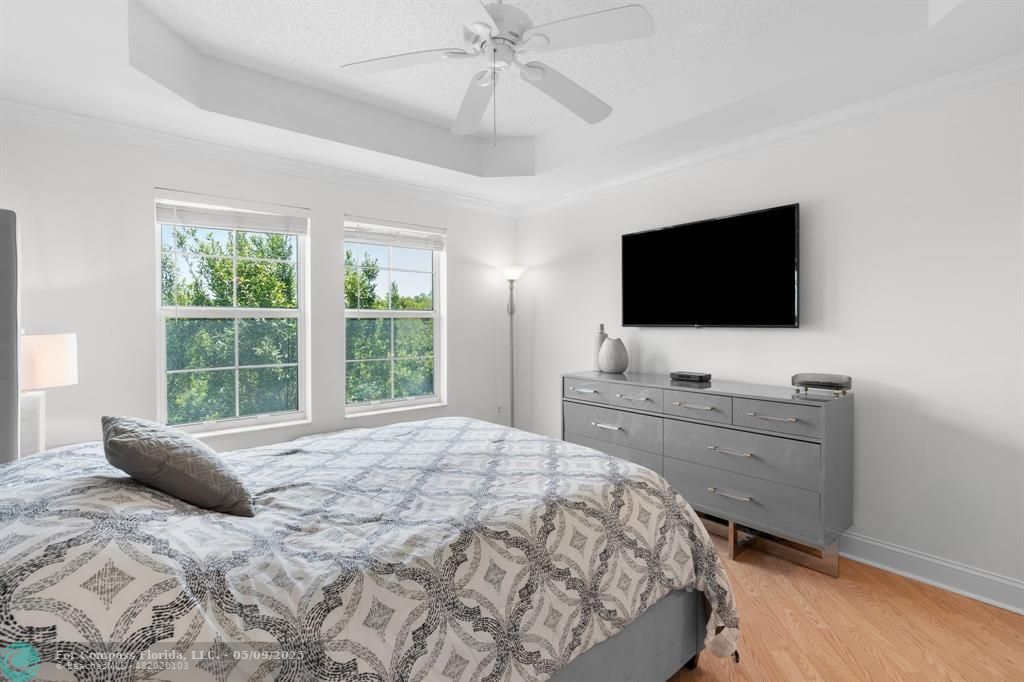 2417 Tuscany Way, Unit 2417 Boynton Beach, FL 33435 - Photo 22 of 27 a bedroom with a bed and a flat screen tv