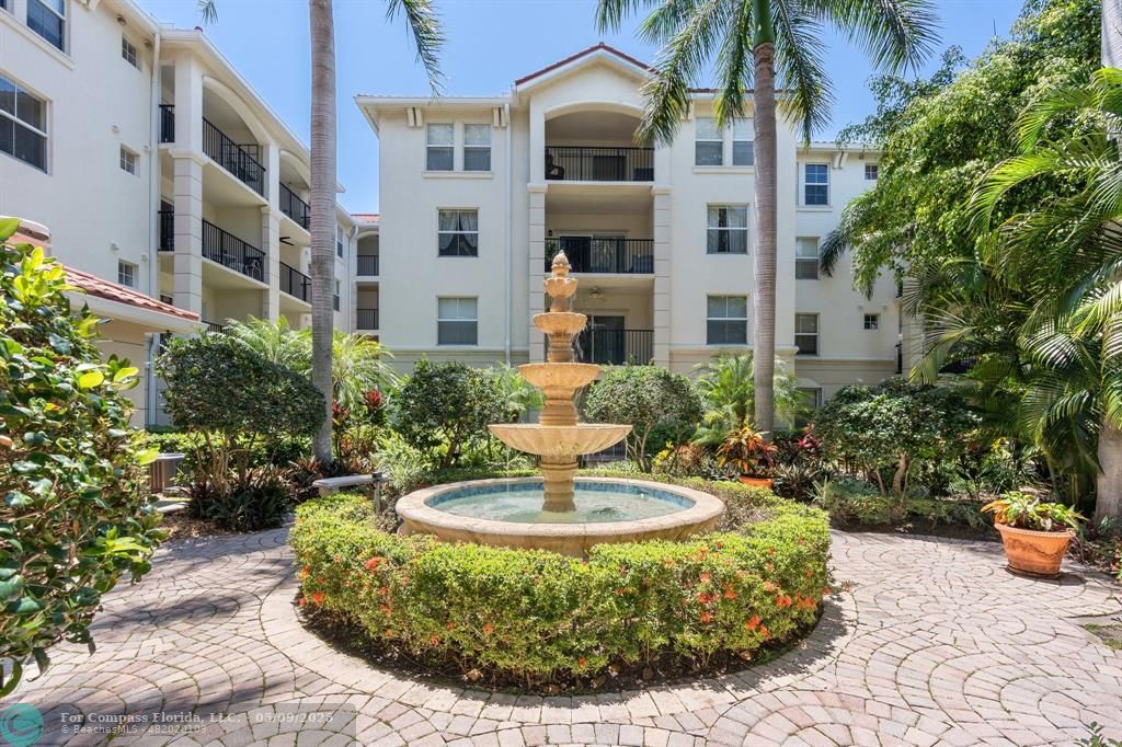 2417 Tuscany Way, Unit 2417 Boynton Beach, FL 33435 - Photo 23 of 27 a view of a house with a fountain in a patio
