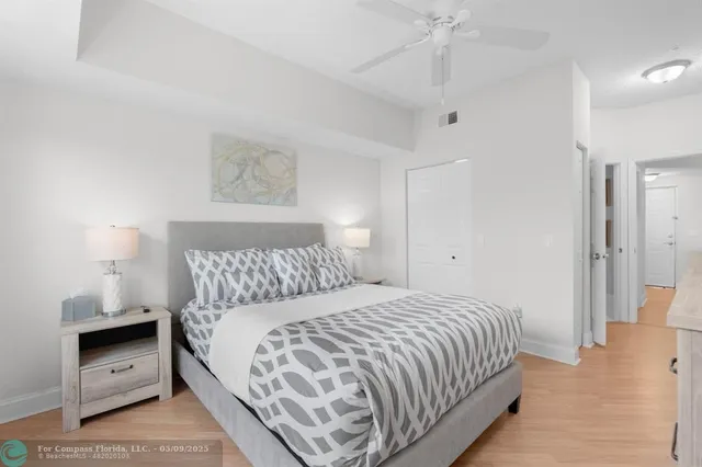 a bedroom with a bed and a lamp