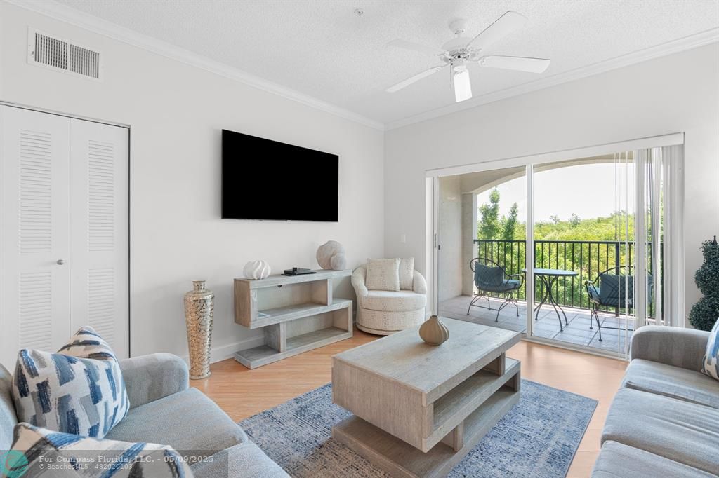 2417 Tuscany Way, Unit 2417 Boynton Beach, FL 33435 - Photo 10 of 27 a living room with furniture and a flat screen tv