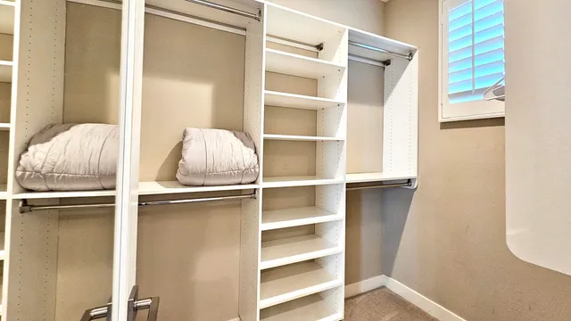 a bedroom with a bed and cabinets