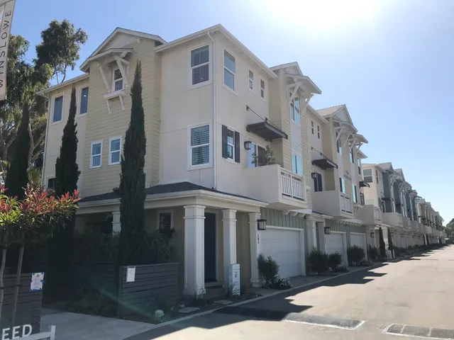 a living room with furniture kitchen view and a fireplace