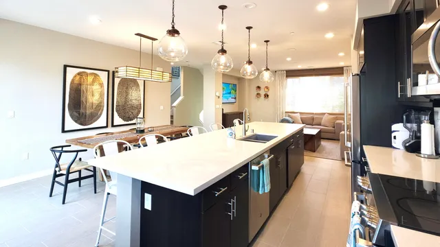 a large kitchen with kitchen island a sink a counter space and stainless steel appliances