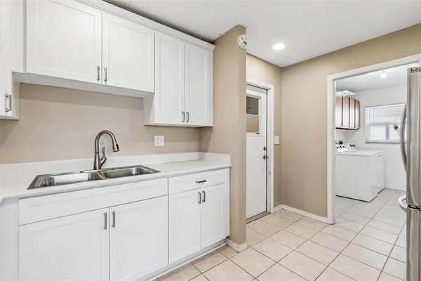 a kitchen with a sink and cabinets