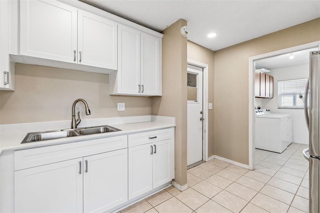 209 Genet Court Sun City Center, FL 33573 - Photo 13 of 31 a kitchen with a sink and cabinets