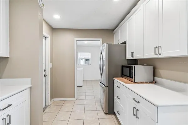 a kitchen with stainless steel appliances a refrigerator and cabinets