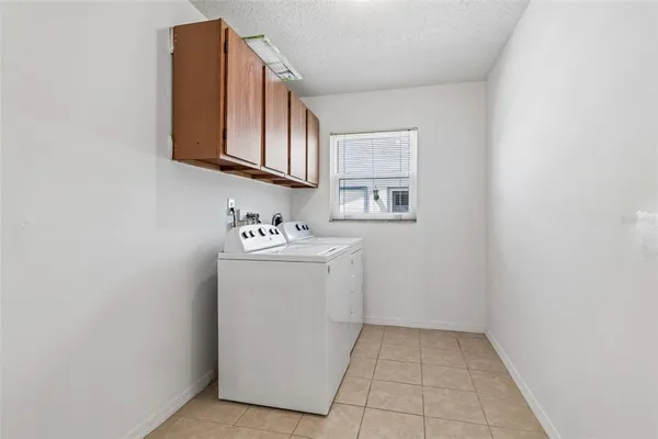 a utility room with a sink washer and dryer