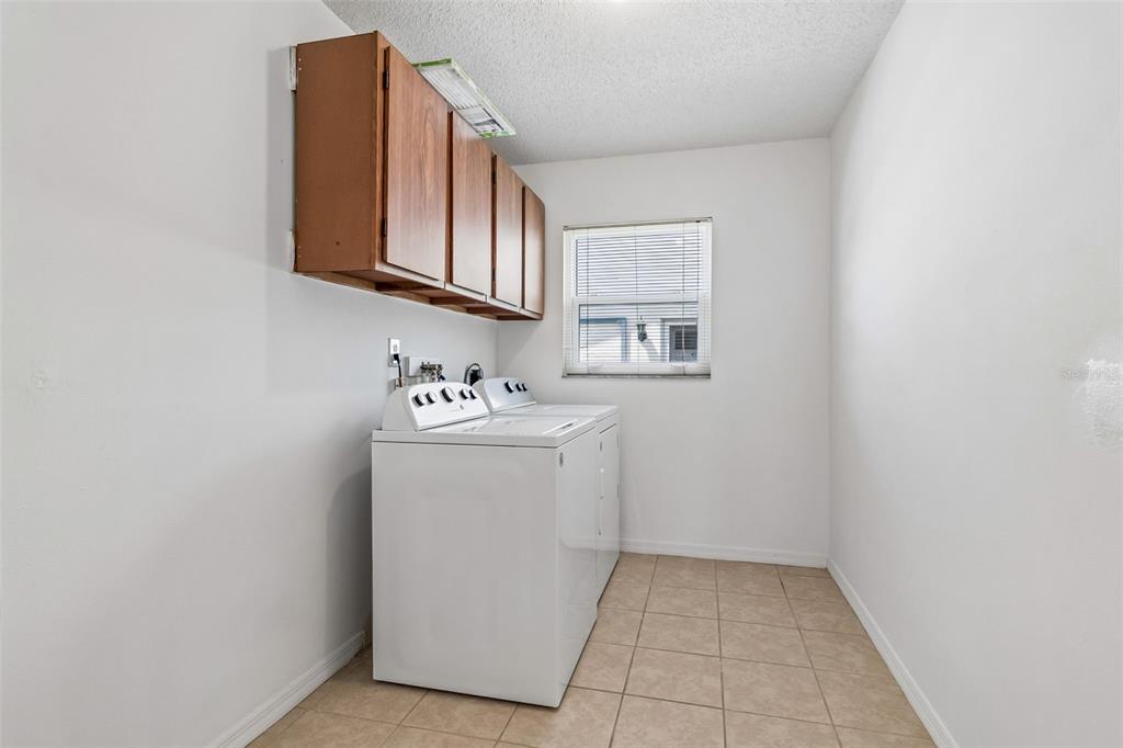 209 Genet Court Sun City Center, FL 33573 - Photo 15 of 31 a utility room with a sink washer and dryer