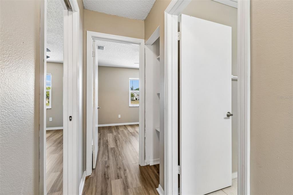 209 Genet Court Sun City Center, FL 33573 - Photo 16 of 31 a view of a hallway with wooden floor and closet area