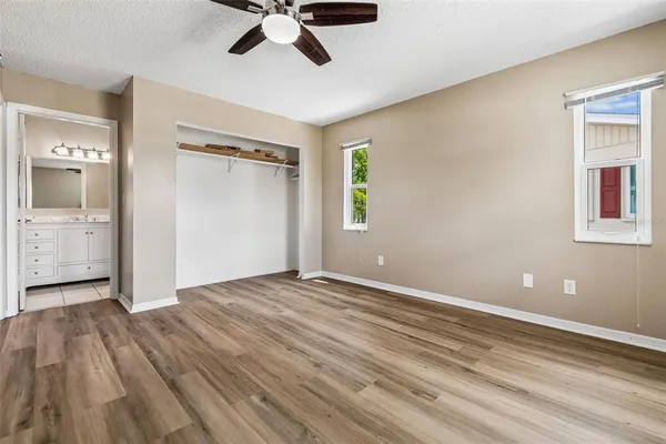 a view of empty room with wooden floor and window