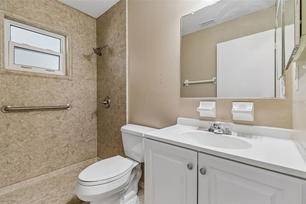209 Genet Court Sun City Center, FL 33573 - Photo 24 of 31 a bathroom with a sink toilet and shower