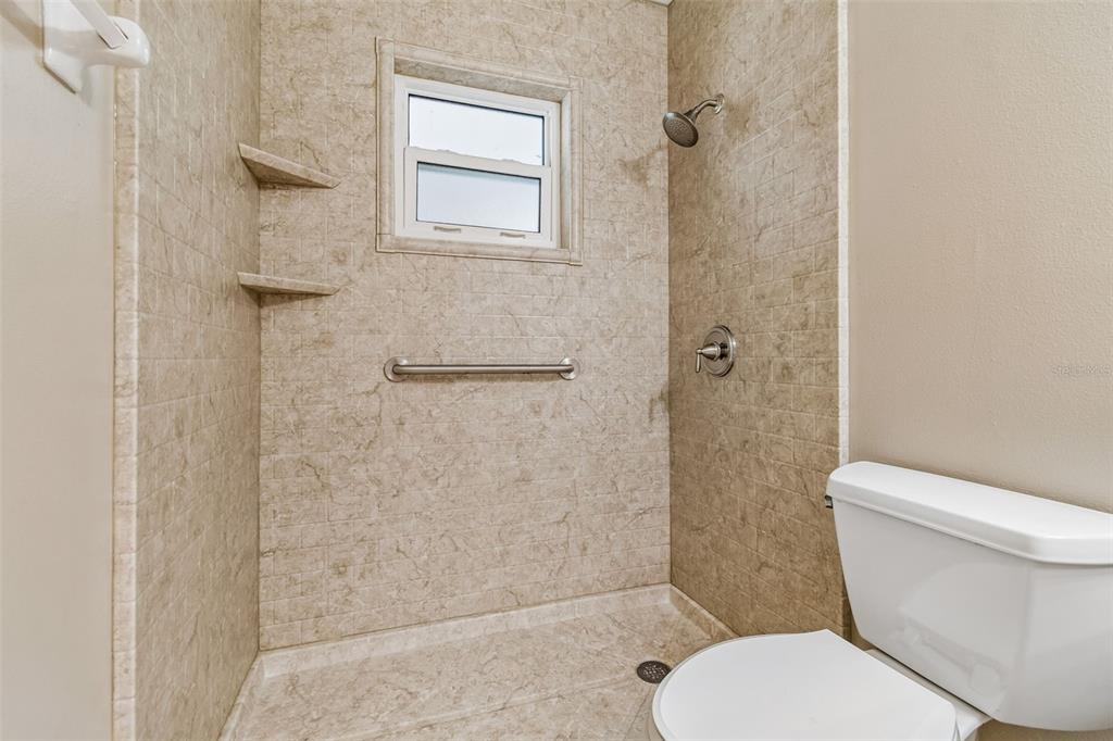 209 Genet Court Sun City Center, FL 33573 - Photo 25 of 31 a white toilet sitting next to a bathroom sink