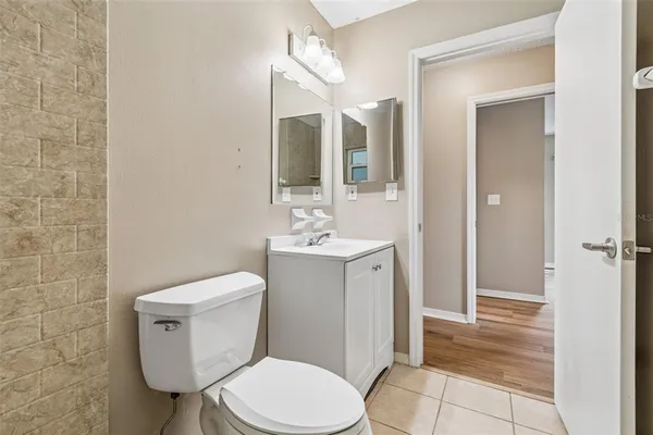 a white toilet sitting next to a bathroom sink