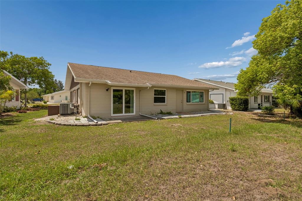 209 Genet Court Sun City Center, FL 33573 - Photo 29 of 31 a view of a house with swimming pool and a yard