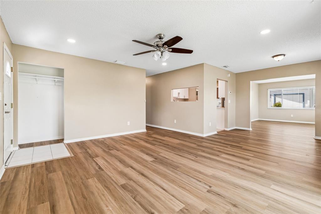 209 Genet Court Sun City Center, FL 33573 - Photo 5 of 31 a view of an empty room with window and wooden floor