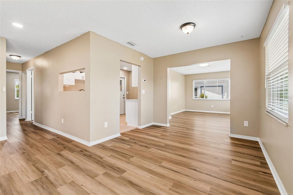 209 Genet Court Sun City Center, FL 33573 - Photo 6 of 31 a view of empty room with wooden floor and fan