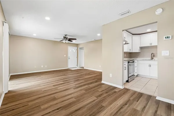 a view of a kitchen with wooden floor and a sink