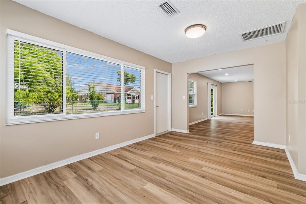 209 Genet Court Sun City Center, FL 33573 - Photo 9 of 31 a view of empty room with wooden floor and fan