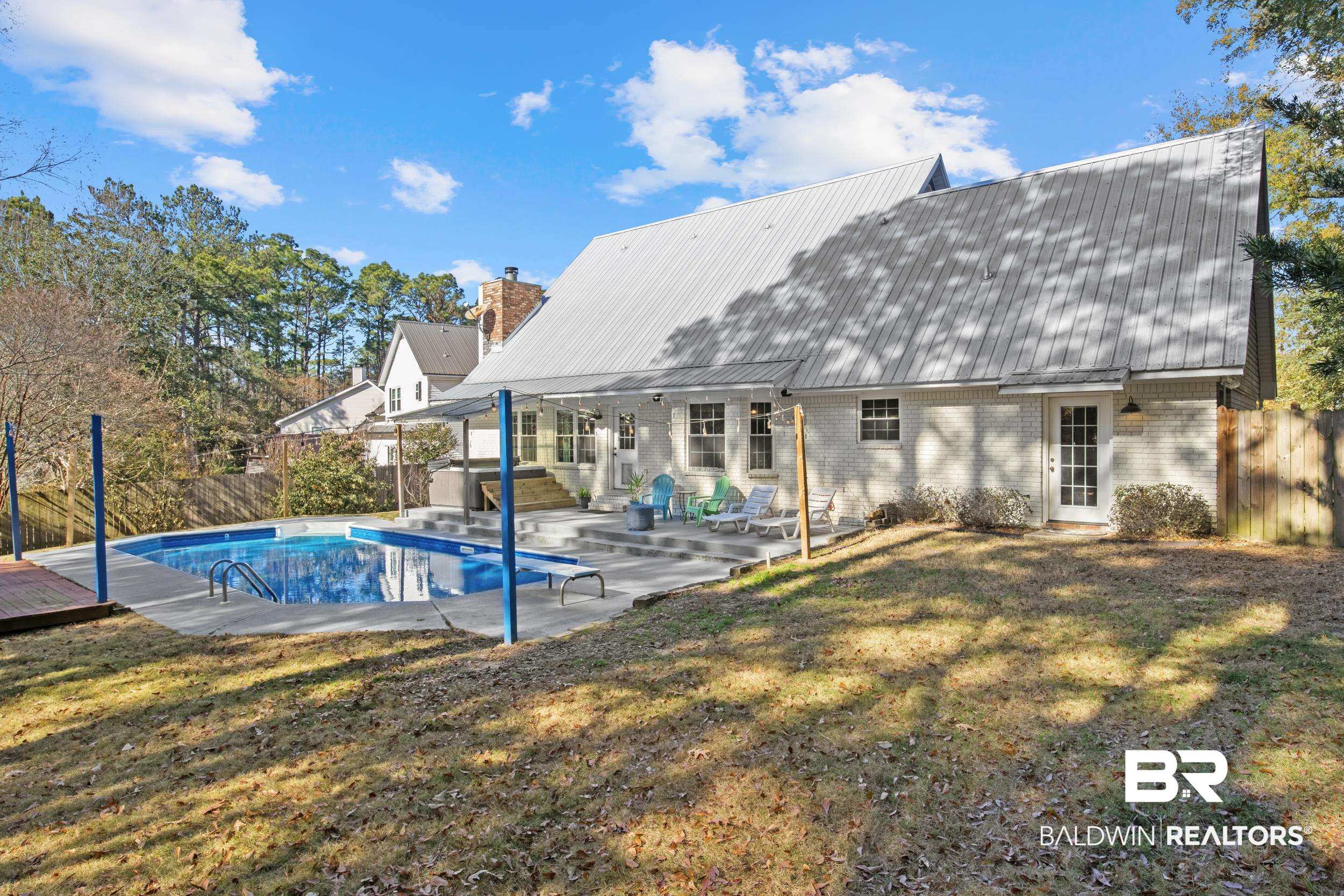 131 Marikesh Drive Daphne, AL 36526 - Photo 28 of 29 Back of property with a patio, a yard, and a jacuzzi