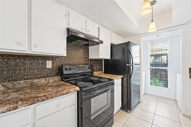 a kitchen with stainless steel appliances granite countertop a refrigerator stove and sink