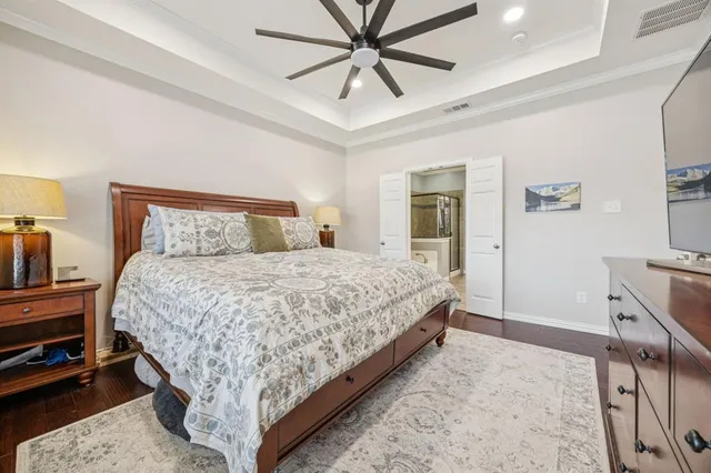 a bedroom with a bed and a chandelier