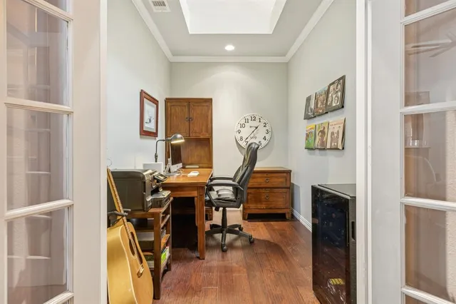 a view of a workspace with furniture and wooden floor