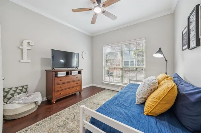 a bedroom with furniture and a flat screen tv